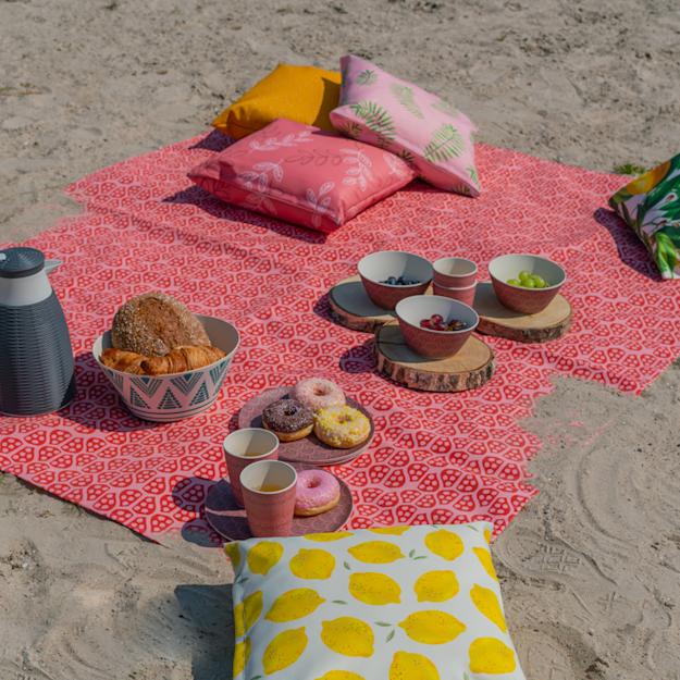 Image of a cheap picnic blanket on the beach. Print with your own design!