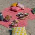 Image of a cheap picnic blanket on the beach. Print with your own design!
