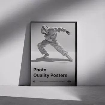 Framed photo quality poster leaning against a wall, featuring a black and white image of a dancer in motion with the text