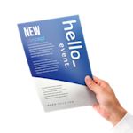 A man holding a flyer printed by Helloprint