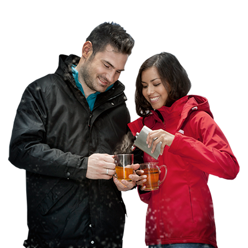 A couple enjoying a drink from a hip flask drinking bottle available at Helloprint with a custom logo printed on the front