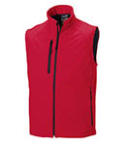 A red coloured sleeveless soft shell body warmer available at Helloprint with a custom logo or image printed on the side.