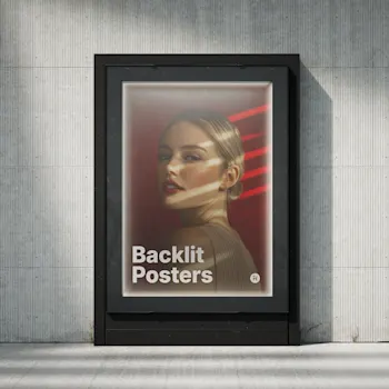 Backlit poster displayed in a black frame against a concrete wall, featuring a portrait of a woman with red lighting accents and the text 