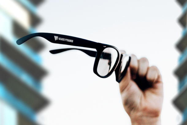 picture of printed sunglasses being held aloft